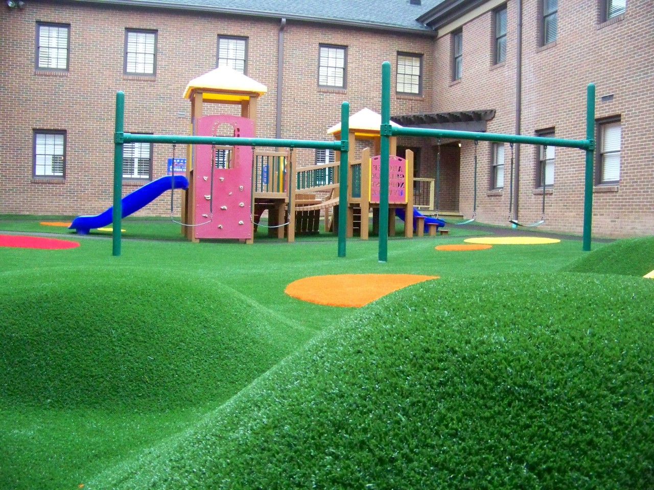 Hilly artificial turf playground by Southwest Greens of Metro New York
